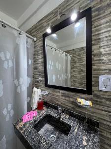 a bathroom with a sink and a mirror at Departamento Turistico Liro in Santa Lucía