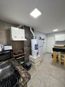 a kitchen with a refrigerator and a counter top at Departamento Turistico Liro in Santa Lucía +4 photos