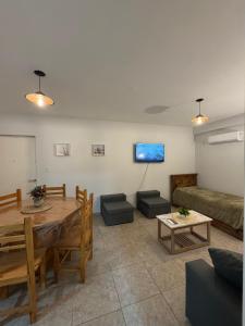 a living room with a table and a couch at Departamento Turistico Liro in Santa Lucía