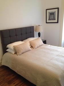 a bedroom with a large bed with two pillows at Caledonian Apartment in Edinburgh