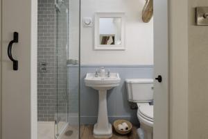 a bathroom with a sink and a toilet and a shower at Flat 2 Martins House in Stow on the Wold +13 photos