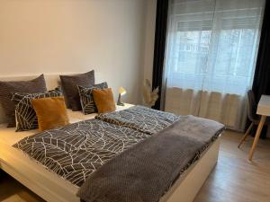 a bedroom with a bed with pillows and a window at Sonas in the city center in Karlovac