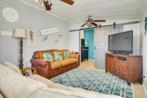 a living room with leather furniture and a flat screen tv at 4 Mi to Beach Home with Pool and Golf in Port Isabel! in Port Isabel