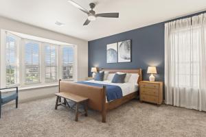 a bedroom with a bed and a ceiling fan at Luxe Retreat with EV Charger & Putting Green in Frisco
