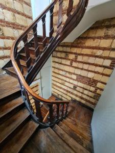 a wooden spiral staircase in a brick wall at Le Saint Aubert in Arras