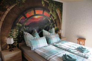 a bedroom with a wall mural with a bed at FeWo Schätzler in Falkenstein