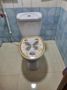 a toilet with a decorated seat in a bathroom at Lukas guest haose in K'obulet'i +4 photos