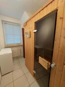 a large flat screen tv in a wooden wall at Birkenquartier in Zingst +5 photos