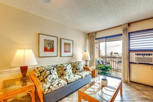 a living room with a couch and a table at Walk to Nawiliwili Harbor Condo with Saltwater Pool in Lihue