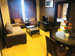 a living room with a couch and a table at Hotel Felda Residence Kuala Terengganu in Kuala Terengganu