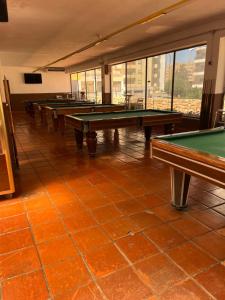 a row of ping pong tables in a room at Praia da Rocha Apartamento Costa Azul in Portimão