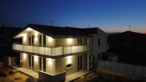 a building with lights on it at night at Villaggio Camping Costa Verde in Marina di Montenero