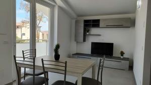 a kitchen and dining room with a table and chairs at Villaggio Camping Costa Verde in Marina di Montenero