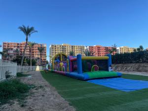 a childrens playground with a play set on the grass at Porto Golf Marina Resort New Alamein North Coast in El Alamein