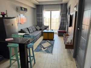 a living room with a couch and a table at Porto Golf Marina Resort New Alamein North Coast in El Alamein
