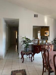 a living room with a table with a potted plant on it at Peaceful stay at Grandmas house in Kissimmee