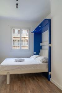 a bedroom with a bed with a blue headboard at 2 pièces - Clim - tram à 5' centre à 15' in Nice
