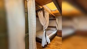 a room with a bunk bed with curtains in it at Modern Apartment Betina 45 m² + sea view in Betina