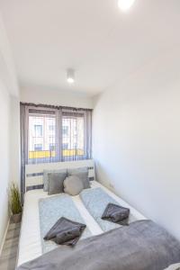 a bedroom with a large bed with two pillows at Gems of Budapest - Onyx Suite in Budapest