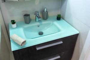 a bathroom sink with a blue counter top at Gems of Budapest - Onyx Suite in Budapest +15 photos