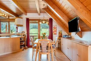 a kitchen and dining room with a table and chairs at Ferienwohnung Weiherblick in Hornberg