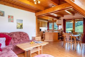 a living room with a couch and a table at Ferienwohnung Weiherblick in Hornberg