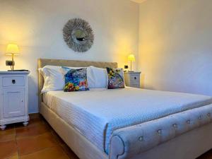 a bedroom with a large bed with a mirror on the wall at Rooms hub Torre di Cesare in Maiori +8 photos