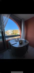 a table in a room with a large window at Appartement Marina in Le Barcarès