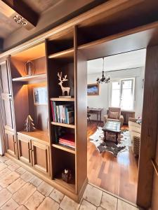 a living room with a sliding glass door leading into a living room at Dimora Il Feudo - Predazzo in Predazzo
