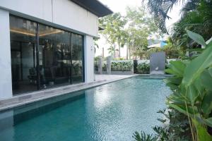 a swimming pool in front of a house at Seda Abreeza Davao in Davao City