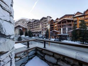 a view from a balcony of a city with buildings at Appartement rénové au cœur de Val d'Isère - 1 chambre + coin montagne, balcon sud, parking inclus - FR-1-567-95 in Val dʼIsère