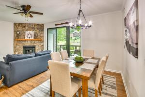 a dining room with a table and a couch at Mtn Cabin with Balcony and View in Burnsville! in Burnsville