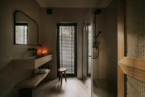 a bathroom with a sink and a mirror at Domek w Lesie in Rozogi
