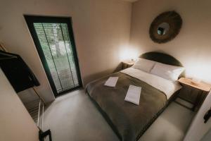 a small bedroom with a bed and a window at Domek w Lesie in Rozogi