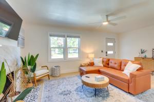 a living room with a couch and a table at Private Hot Tub and Fenced Yard Sleek Gulfport Home in St Petersburg