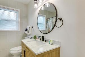 a bathroom with a sink and a mirror at Private Hot Tub and Fenced Yard Sleek Gulfport Home in St Petersburg +30 photos