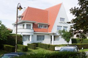 a white house with an orange roof at Villa Emilia in De Haan +15 photos