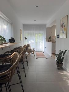ein Wohnzimmer mit Stühlen und einem Tisch sowie eine Küche in der Unterkunft Two Tangerines in Milicz