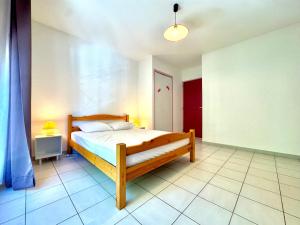 a bedroom with a wooden bed in a room at Annexe Boullée Appartement 3 - Thermes Neyras les Bains in Meyras