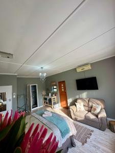 a living room with a bed and a couch at Mia Amore in Caledon