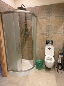 a bathroom with a shower and a toilet at 1904 Studio in Świnoujście +14 photos