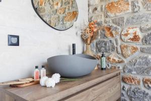 a bathroom with a large bowl on a wooden dresser at Petres Luxury Villas with heated private pool in Agia Galini +25 photos