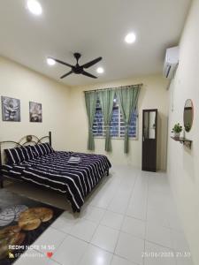 a bedroom with a bed and a ceiling fan at Mawar Inn Gambang Kuantan in Gambang