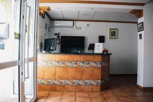 a bar in a room with a tiled counter at HOTEL Paquita in Chipiona