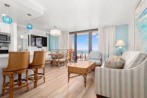 a living room with a couch and chairs and a kitchen at Costa Del Sol Resort in Fort Lauderdale