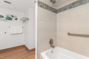a bathroom with a bath tub and a toilet at Costa Del Sol Resort in Fort Lauderdale