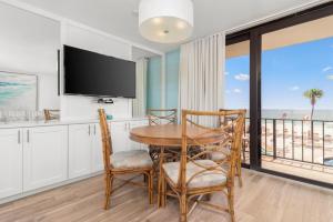 a dining room with a table and chairs and a television at Costa Del Sol Resort in Fort Lauderdale