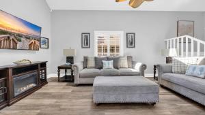 a living room with two couches and a tv at Relaxing Cherry Grove Beach House with Balcony Family Fun in Myrtle Beach