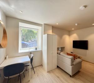 a living room with a table and a chair and a couch at Chic and Modern Studio - Central in Oslo