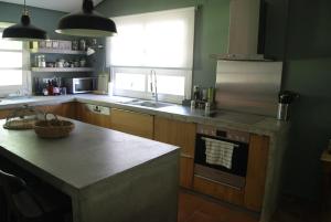 a kitchen with a sink and a stove top oven at Villa Trypiti in Limenaria
